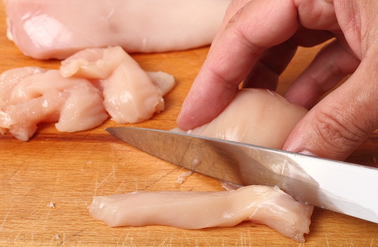 Slicing chicken breast into strips